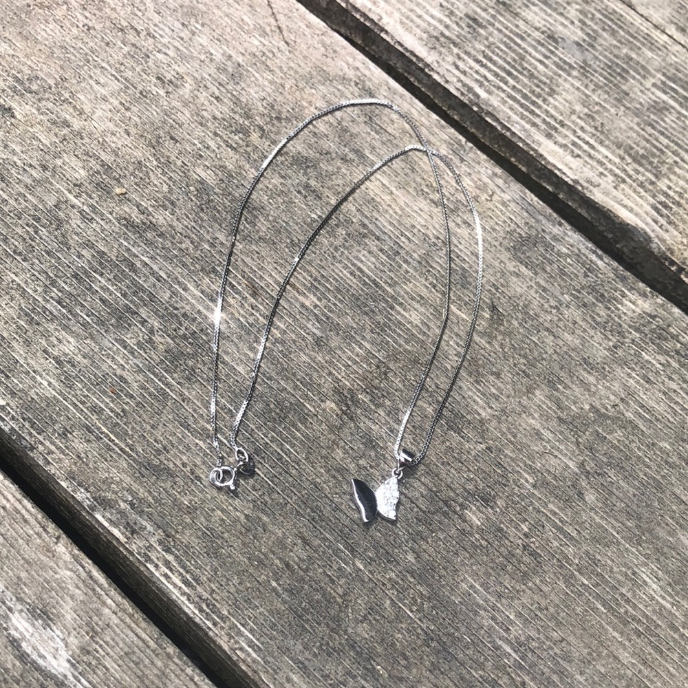 Silver sparkly butterfly necklace.